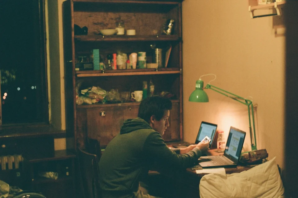 photo by max shilov man in black jacket using laptop computer